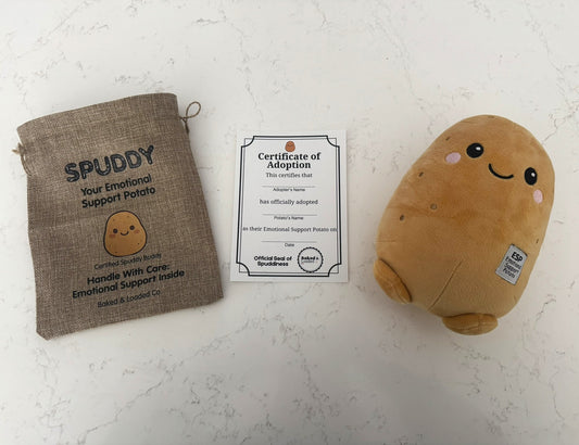 Plush potato toy with adoption certificate and drawstring bag on a light background